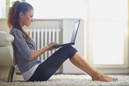 Young woman sitting on the floor with laptop - AZarubaika/E+/Getty Images