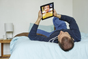Man using iPad to video chat with young boy - Kathleen Finlay/Image Source/Getty Images