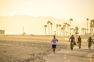 People jogging and cycling on Venice Beach, California